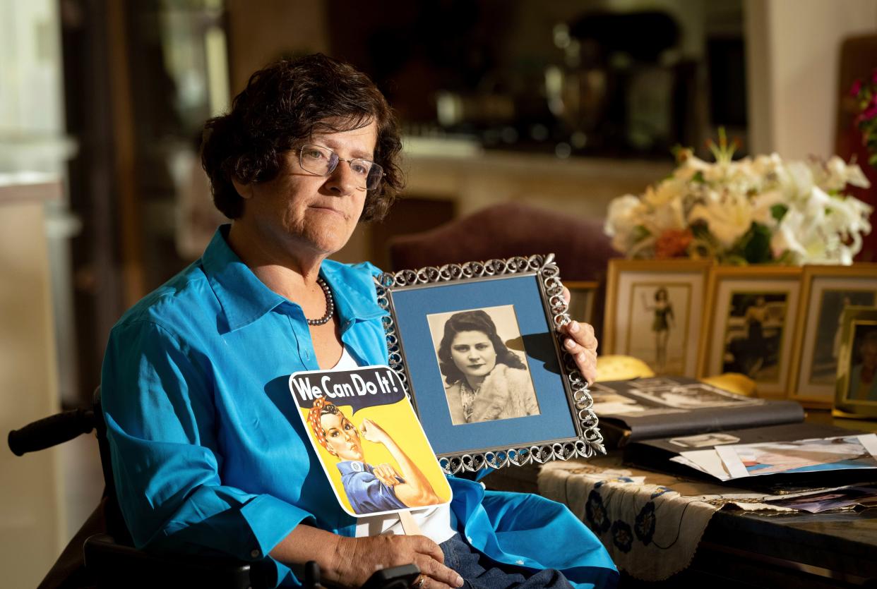 Dorene Giacopini holds up a photo of her mother Primetta Giacopini while posing for a photo at her home in Richmond, Calif. on Monday, Sept. 27, 2021.  Primetta Giacopini's life ended the way it began — in a pandemic. She was two years old when she lost her mother to the Spanish flu in Connecticut in 1918. Giacopini contracted COVID-19 earlier this month. The 105-year-old struggled with the disease for a week before she died Sept. 16.