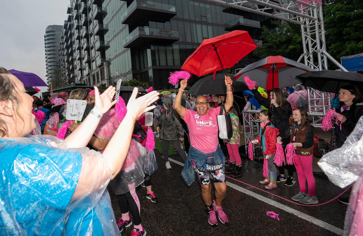 Breast cancer survivors cheer as they make their way in a survivors procession before the start of the 2023 Komen Columbus Race for the Cure.