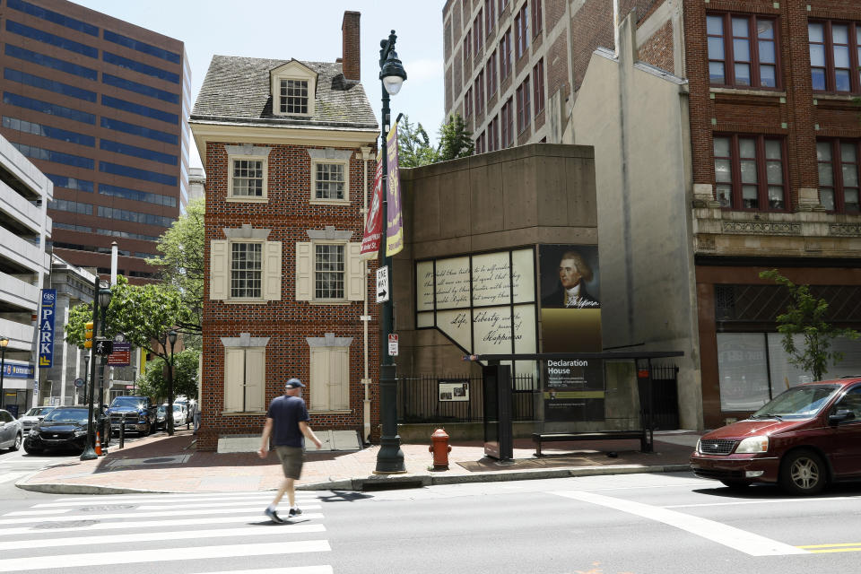 In this June 30, 2020, photo, a man walks in front of the Declaration House in Philadelphia. Countless words have been written about the Declaration of Independence and Thomas Jefferson, but few about Robert Hemings, the slave who was on hand as Jefferson famously declared that “All men are created equal.” According to the National Park Service, Hemings is not included in the exhibit texts of the Declaration House, a reconstruction of the home Jefferson stayed in as a guest of the Philadelphia bricklayer Jacob Graff. (AP Photo/Matt Slocum)