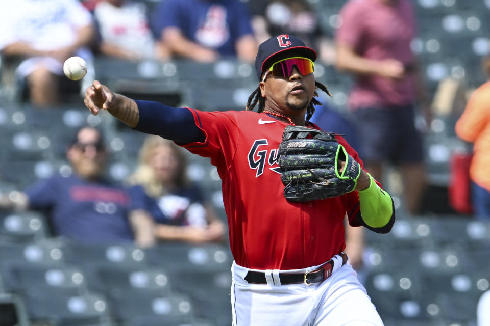 Cleveland Guardians' José Ramírez throws out Los Angeles Dodgers' Will Smith at first base during the third inning in the continuation of a suspended baseball game, Thursday, Aug. 24, 2023, in Cleveland. The game was suspended the night before due to inclement weather. (AP Photo/Nick Cammett)