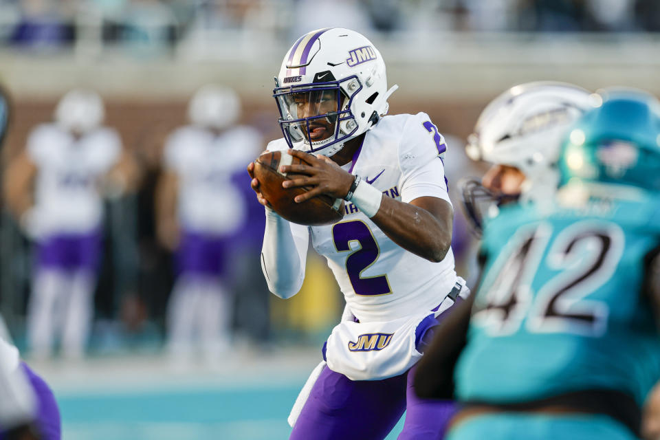 James Madison quarterback Jordan McCloud (2) carries the football against Coastal Carolina during the first half of an NCAA college football game in Conway, N.C., Saturday, Nov. 25, 2023. (AP Photo/Nell Redmond)