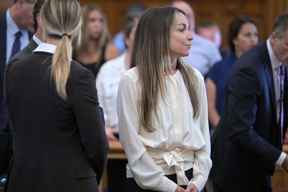 Karen Read, center, stands amid her lawyers during a break in proceedings during Read's trial in Norfolk Superior Court, Friday, June 21, 2024, in Dedham, Mass. Read, 44, is accused of running into her Boston police officer boyfriend with her SUV in the middle of a nor'easter and leaving him for dead after a night of heavy drinking. (AP Photo/Josh Reynolds, Pool)