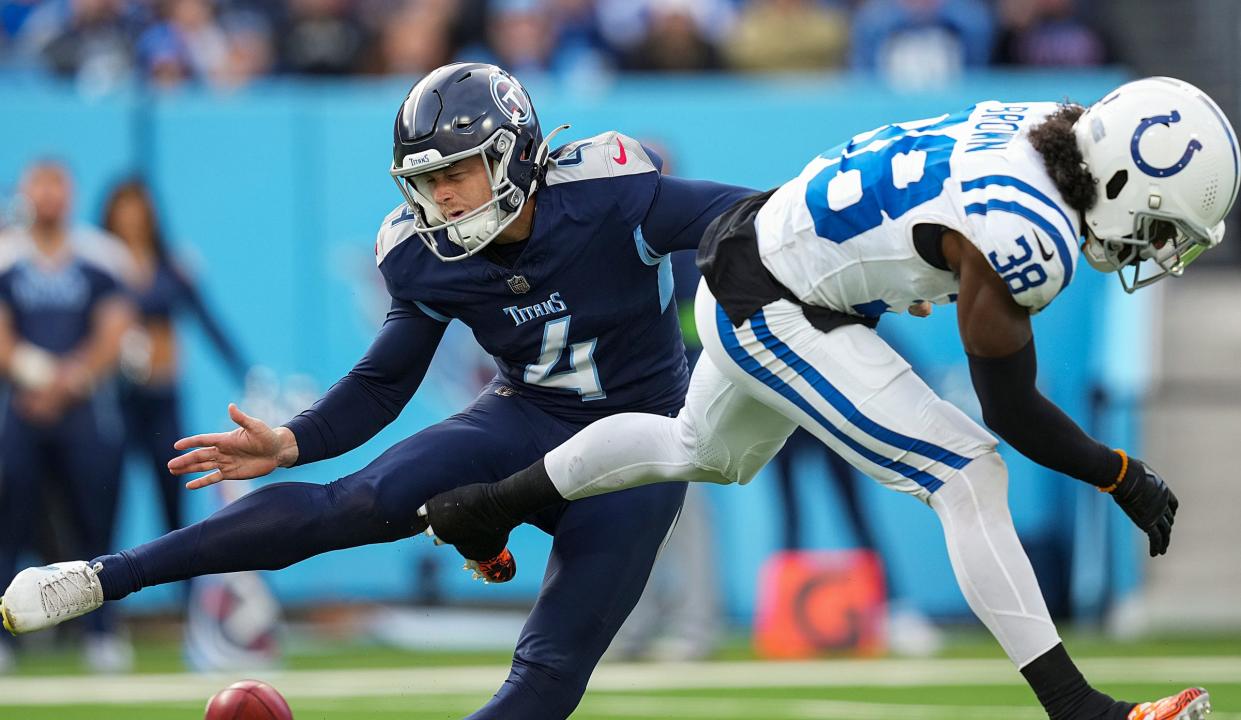 Indianapolis Colts cornerback Tony Brown (38) knocks the ball away from Tennessee Titans punter Ryan Stonehouse (4) before he could punt on Dec. 3, 2023, in Nashville, Tenn.