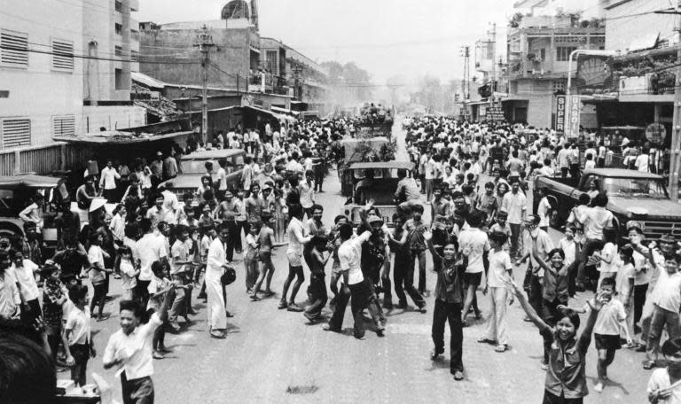 Saigon's youths watch North Vietnamese troops rolling into the city, ending the US's 15-year involvement in Vietnam, on April 30, 1975