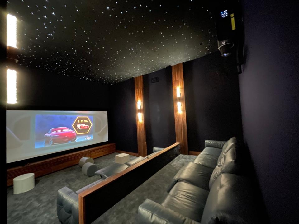 A home theater with "Cars" on the screen.