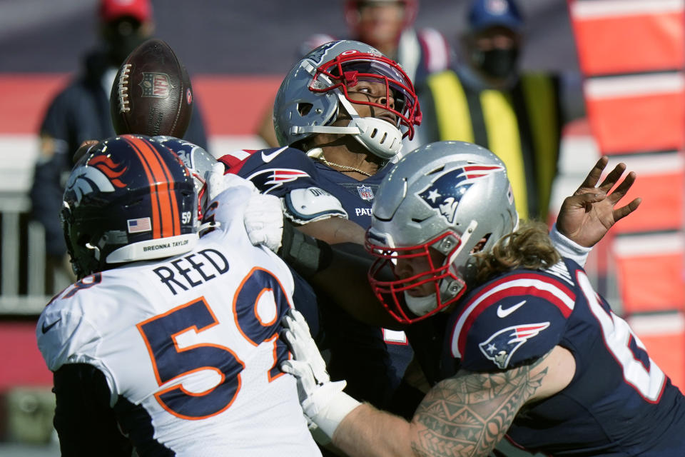 New England Patriots quarterback Cam Newton, rear, fumbles in the second half of an NFL football game against the Denver Broncos, Sunday, Oct. 18, 2020, in Foxborough, Mass. (AP Photo/Steven Senne)