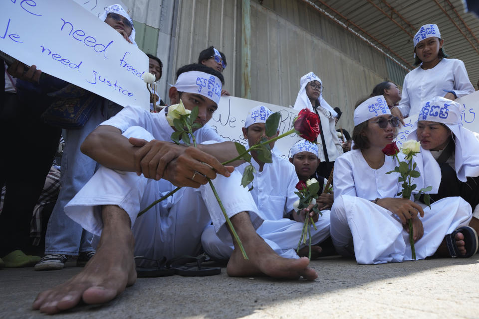 Environmental activists, front row, sit during a protest near Phnom Penh Municipality Court, in Phnom Penh, Cambodia, Tuesday, July 2, 2024. Ten members of a nonviolent environmental activist group in Cambodia were convicted on Tuesday on charges of conspiracy to commit a crime, receiving prison sentences of six years each. (AP Photo/Heng Sinith)