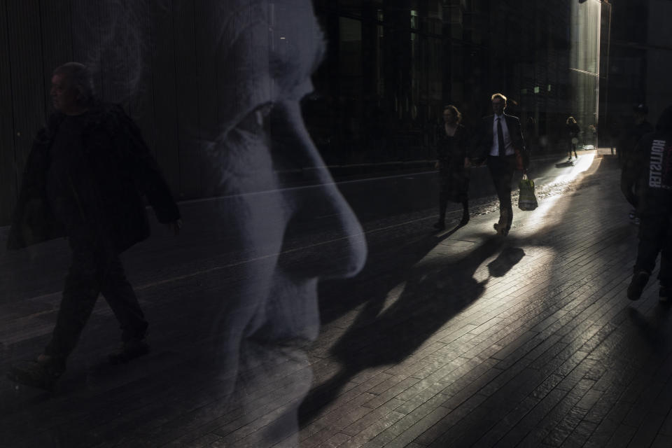 People are reflected in a portrait of late Queen Elizabeth II in London, Friday, Sept. 16, 2022. In June, Britain celebrated Queen Elizabeth II’s Platinum Jubilee — 70 years on the throne — with parties, pageants and a service of thanksgiving. Three months later, the queen died, aged 96, at Balmoral Castle in Scotland. (AP Photo/Felipe Dana)