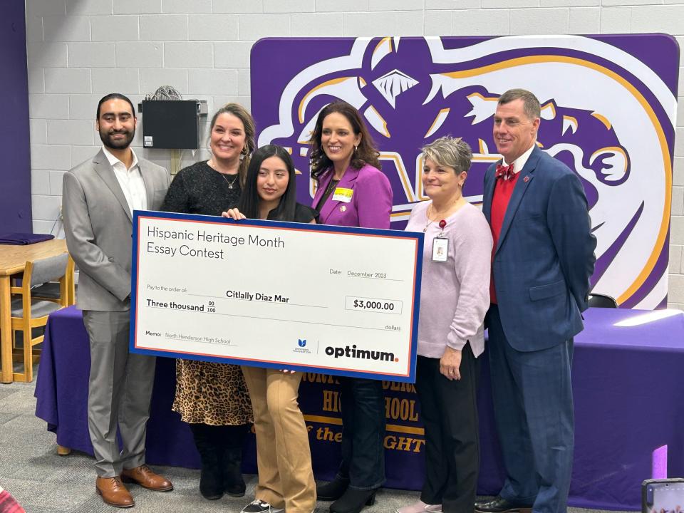 From left to right are Optimum’s Sagar Bhika, North Henderson High School Teacher Julie Holbert, grand prize winner Citlally Diaz, North Carolina State Representative Jennifer Balkcom, Assistant Principal Michelle Mille, and Superintendent of Henderson County Public Schools Mark Garrett.