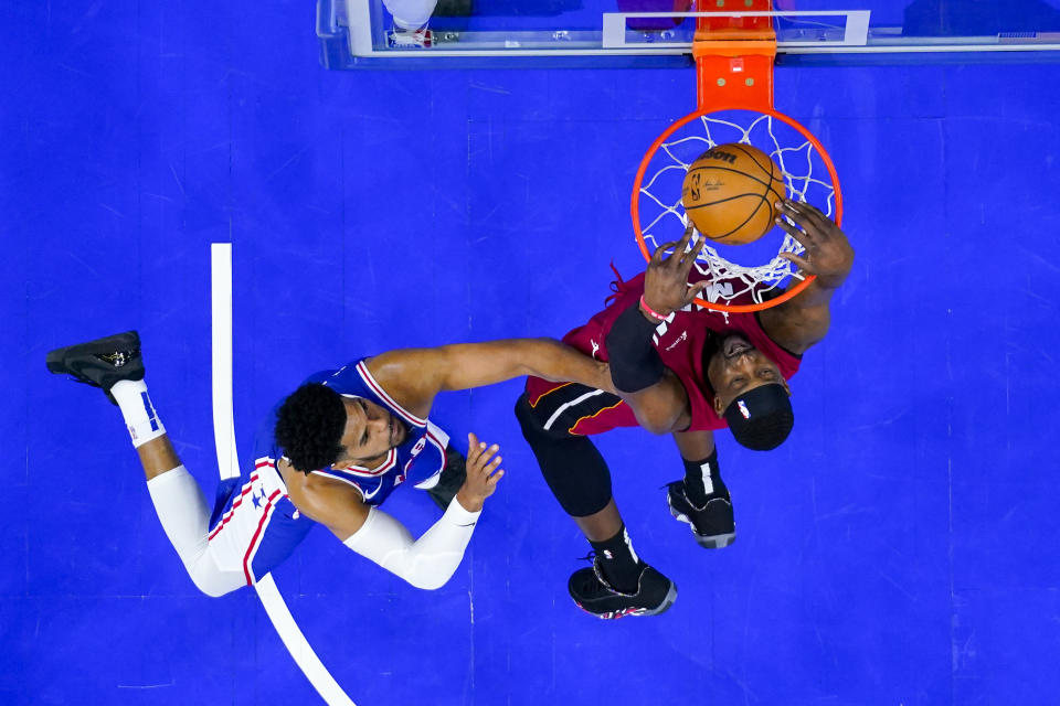 Miami Heat's Bam Adebayo, right, dunks the ball with Philadelphia 76ers' Tobias Harris, left, defending during the second half of an NBA basketball play-in tournament game, Wednesday, April 17, 2024, in Philadelphia. The 76ers won 105-104.(AP Photo/Chris Szagola)