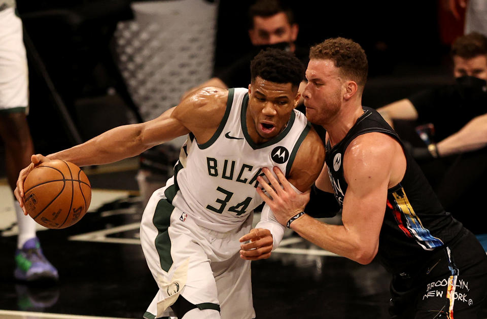 Giannis Antetokounmpo tries to get around Blake Griffin.