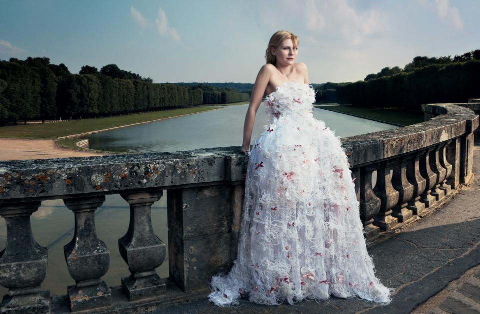 At the Grand Canal of Versailles, Kirsten Dunst, star of Sofia Coppola’s Marie Antoinette, wears a Chanel Haute Couture “Petit Trianon” lace dress with tulle rosettes made for Vogue.