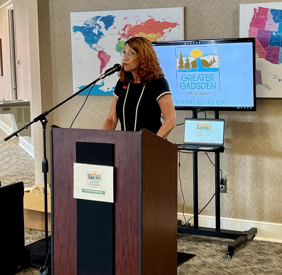 Tina Morrison, executive director of Greater Gadsden Area Tourism, speaks Friday, May 3, 2024, at a ceremony announcing the agency's new branding and logo (seen on the monitor behind her).