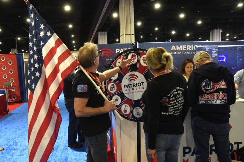 Attendees play a spin-the-wheel game at the Conservative Political Action Conference on Thursday in National Harbor, Md. Photo by Mike Theiler/UPI