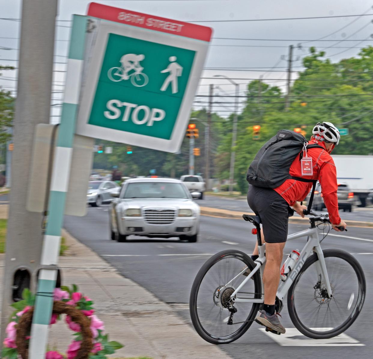 A newly approved law bring Iowa statutes into line with thse in most other states, whch accord cyclists like the one seen here in Indiana, as well as wheelchair users and others on wheels, the same protections in crosswalks as people on foot.