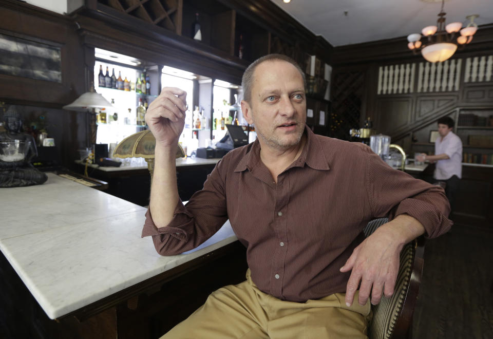 David Napier, owner of The Old City Bar in Richmond’s former slave-trading district, is president of the Shockoe Bottom Neighborhood Association, is photographed in his bar in Richmond, Va., Wednesday April 3, 2014. The association has backed an economic development proposal that includes a baseball stadium. Some opponents argue the national pastime shouldn’t be played were slaves were jailed, bought and sold. Napier says the development can enhance the city’s oldest neighborhood and also pay homage to the hundreds of thousands of slaves that were traded in the streets of the Bottom in the decades leading to the Civil War. (AP Photo/Steve Helber)