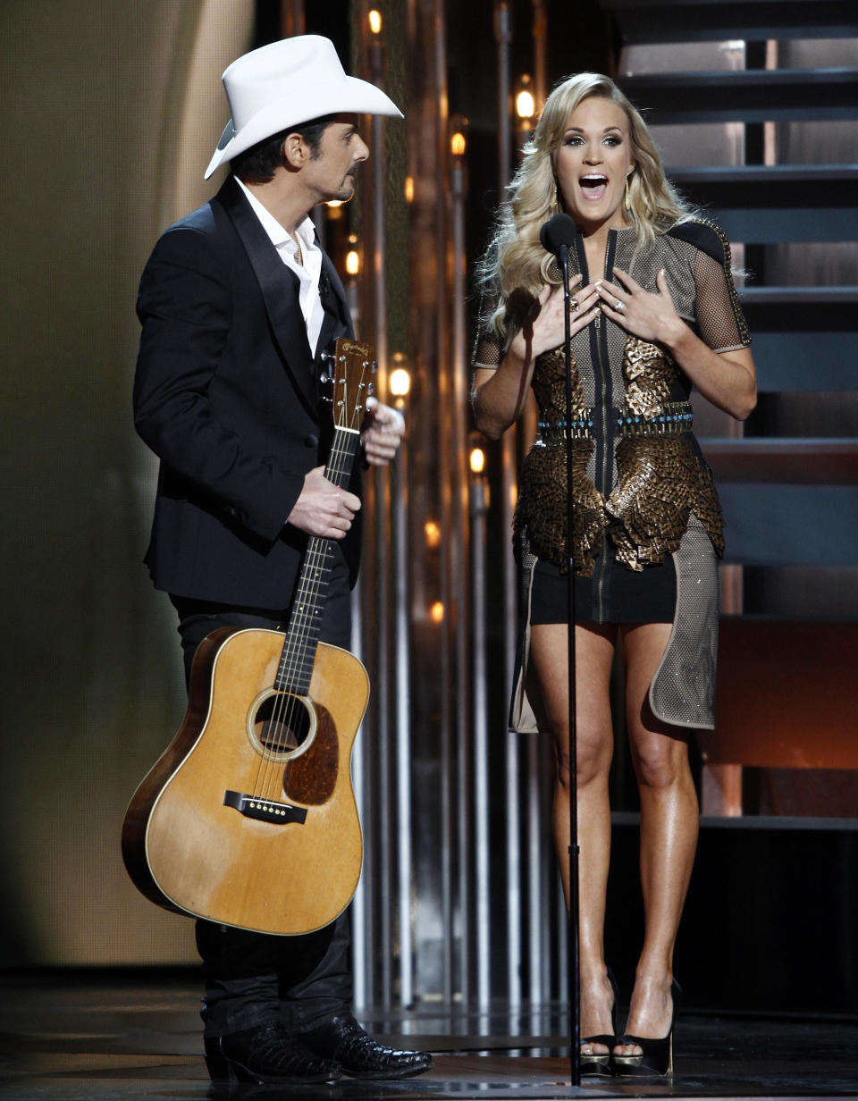 Co-hosts Brad Paisley, left, and Carrie Underwood perform at the 47th annual CMA Awards at Bridgestone Arena on Wednesday, Nov. 6, 2013, in Nashville, Tenn. (Photo by Wade Payne/Invision/AP)