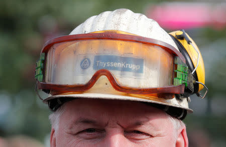 A man wears a helmet with glasses attached during a Thyssenkrupp steel workers protest rally in Bochum, Germany, September 22, 2017, against the planned combination of the group's European steel operations with those of Tata Steel. REUTERS/Wolfgang Rattay