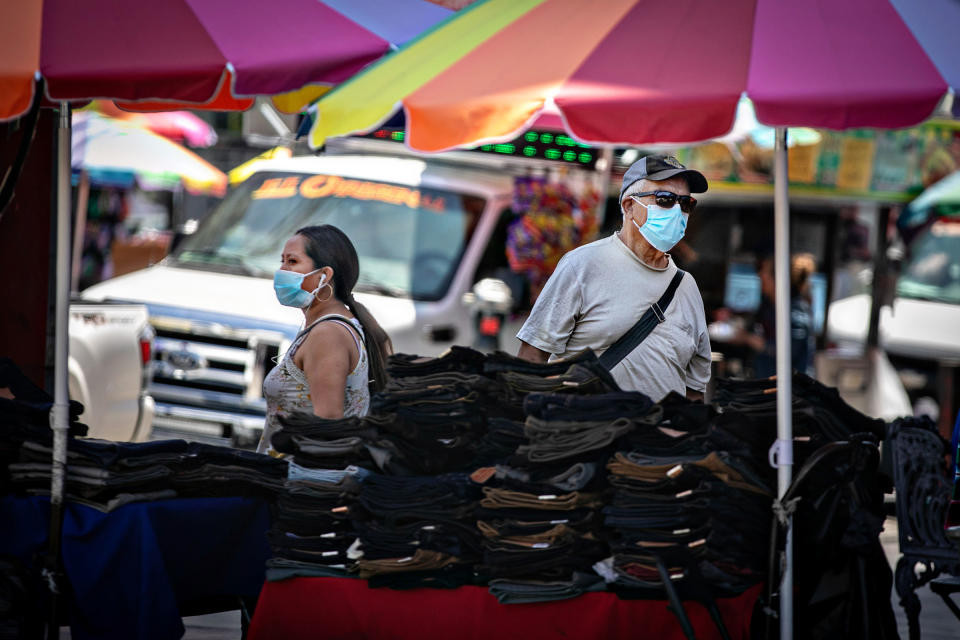 People wearing masks shop and work in Santee Ally in Los Angeles on July 11, 2022.<span class="copyright">Jason Armond—Los Angeles Times/Getty Images</span>