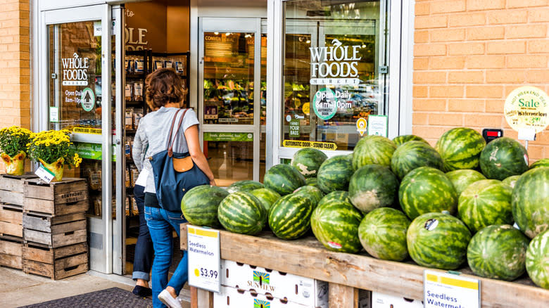 People entering Whole Foods next to Watermelon