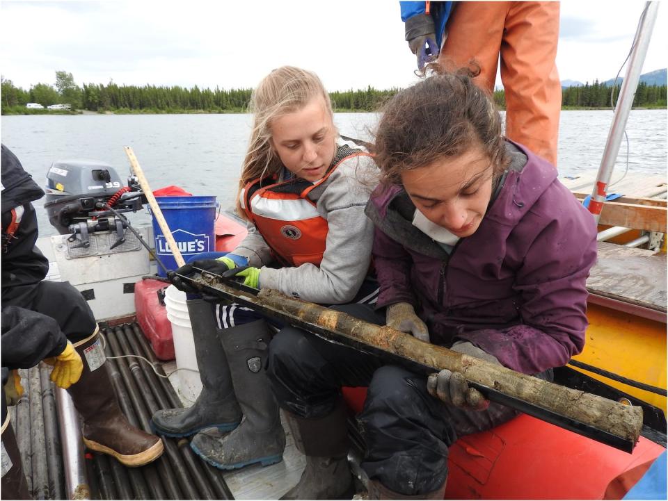 Ellie Broadman, right, an author of this article, holds a sediment core from a lake on Alaska’s Kenai Peninsula. Emily Stone