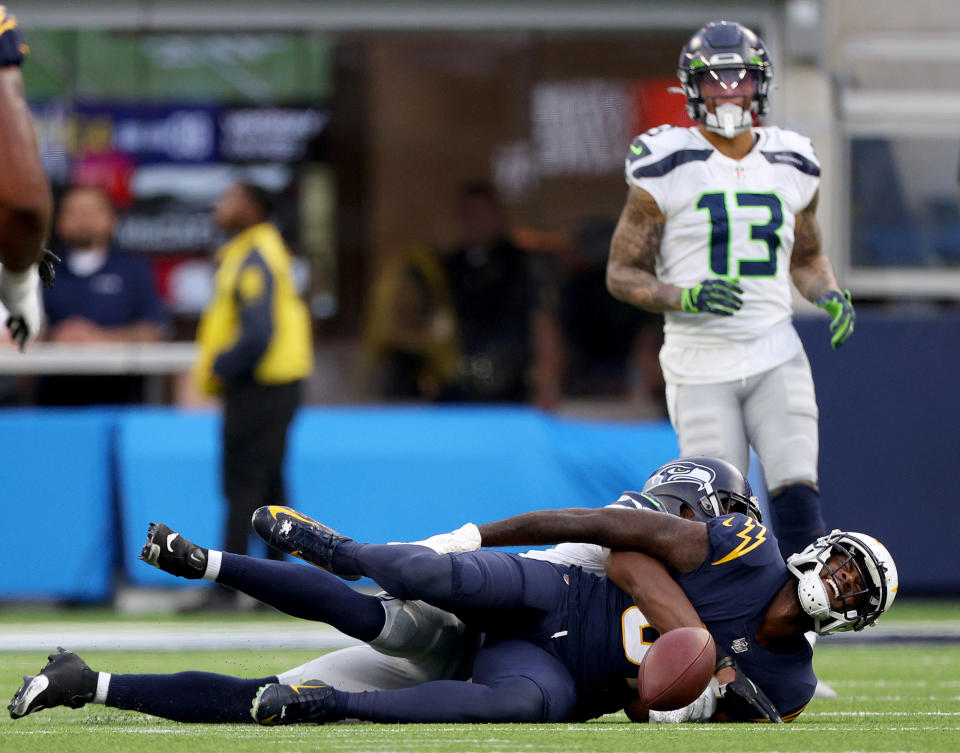 INGLEWOOD, CALIFORNIA - OCTOBER 23:Mike Williams #81 of the Los Angeles Chargers reacts to an injury after he is tackled by Mike Jackson #30 of the Seattle Seahawks as Josh Jones looks on during a 37-23 loss to the Seattle Seahawks at SoFi Stadium on October 23, 2022 in Inglewood, California. (Photo by Harry How/Getty Images)