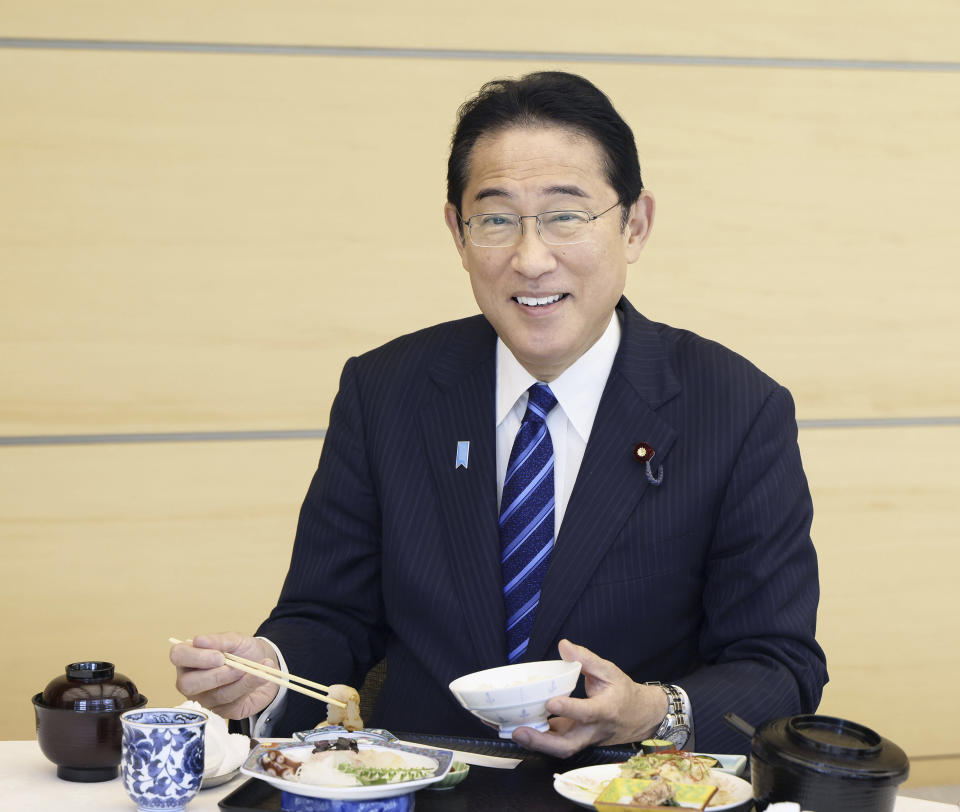 In this photo provided by Cabinet Public Affairs Office, Japanese Prime Minister Fumio Kishida eats the seafood from Fukushima prefecture at lunch at the prime minister's office in Tokyo, Japan, Wednesday, Aug. 30, 2023. (Cabinet Public Affairs Office via AP)