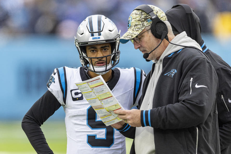 Carolina Panthers quarterback Bryce Young (9) listens as head coach Frank Reich gives him instruction during their NFL football game against the Tennessee Titans Sunday, Nov. 26, 2023, in Nashville, Tenn. (AP Photo/Wade Payne)