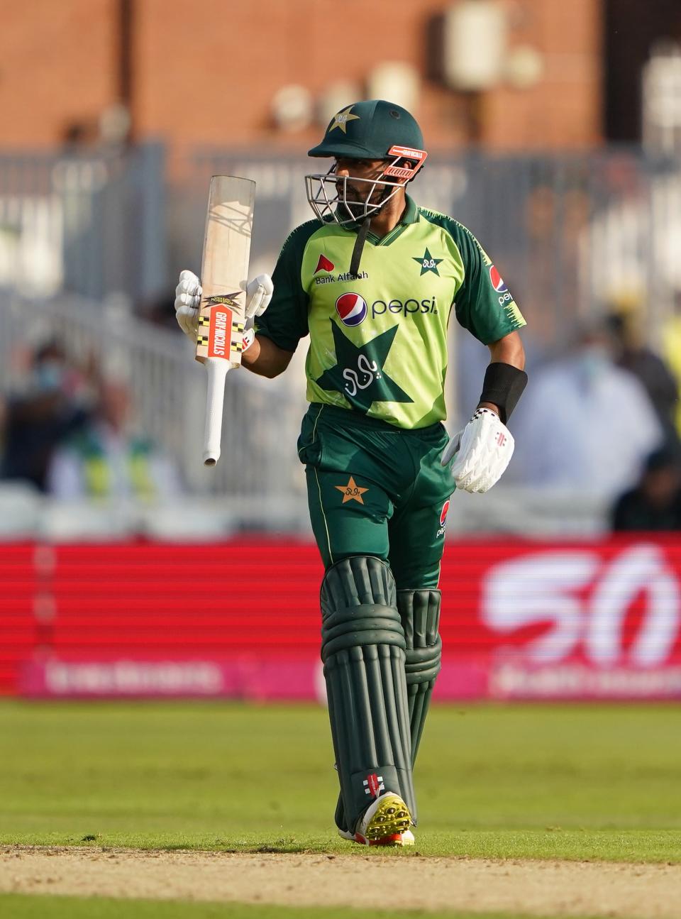 Babar Azam celebrates his half-century (PA Wire)