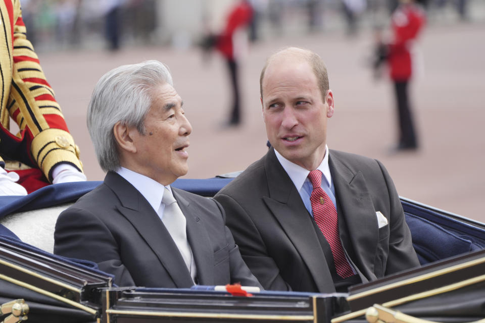 Britain's Prince William, right, sits by Hirofumi Nakasone, the Japan party's head of the official suite, as they arrive at Buckingham Palace during the ceremonial welcome for the State Visit to Britain of the Japanese Emperor and Empress, in London, Tuesday, June 25, 2024. (Jonathan Brady, Pool Photo via AP)