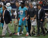 Team staff assist Miami Dolphins' Allen Hurns (17) off the field after he suffered an unknown injury in the first half of a NFL football game against the Dallas Cowboys in Arlington, Texas, Sunday, Sept. 22, 2019. (AP Photo/Michael Ainsworth)