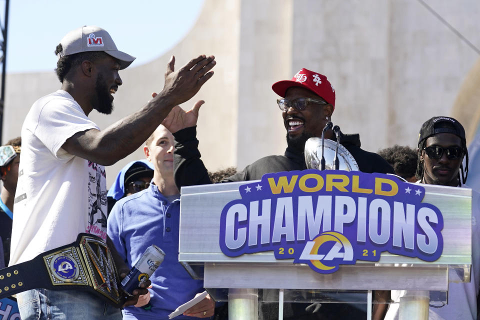Los Angeles Rams linebackers Von Miller, center, and Leonard Floyd, left, celebrate following the team's victory parade in Los Angeles, Wednesday, Feb. 16, 2022, after their win Sunday over the Cincinnati Bengals in the NFL Super Bowl 56 football game. (AP Photo/Marcio Jose Sanchez)