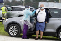 A man gets the coronavirus vaccine at an outdoor vaccination site at Lakewood Ranch Wednesday, Feb. 17, 2021, in Bradenton, Fla. (AP Photo/Chris O'Meara)