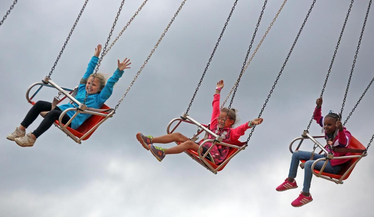 Children fly through the air while riding the Yo-Yo at the Cleveland County Fair.