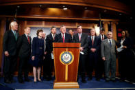 Chairman of the Senate Intelligence Committee Richard Burr (R-NC) and the committee's vice chairman Senator Mark Warner (D-VA)(5th R) stand with members of the committee as they speak to the media about the committee's findings and recommendations on threats to election infrastructure on Capitol Hill in Washington, U.S., March 20, 2018. REUTERS/Joshua Roberts