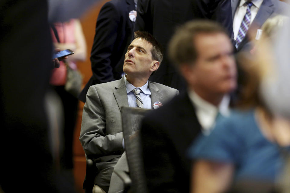 Executive director of the North Carolina Republican party Dallas Woodhouse is seated in the crowd during the public evidentiary hearing on the 9th Congressional District investigation Monday, Feb. 18, 2019, at the North Carolina State Bar in Raleigh, N.C. (Juli Leonard/The News & Observer via AP, Pool)