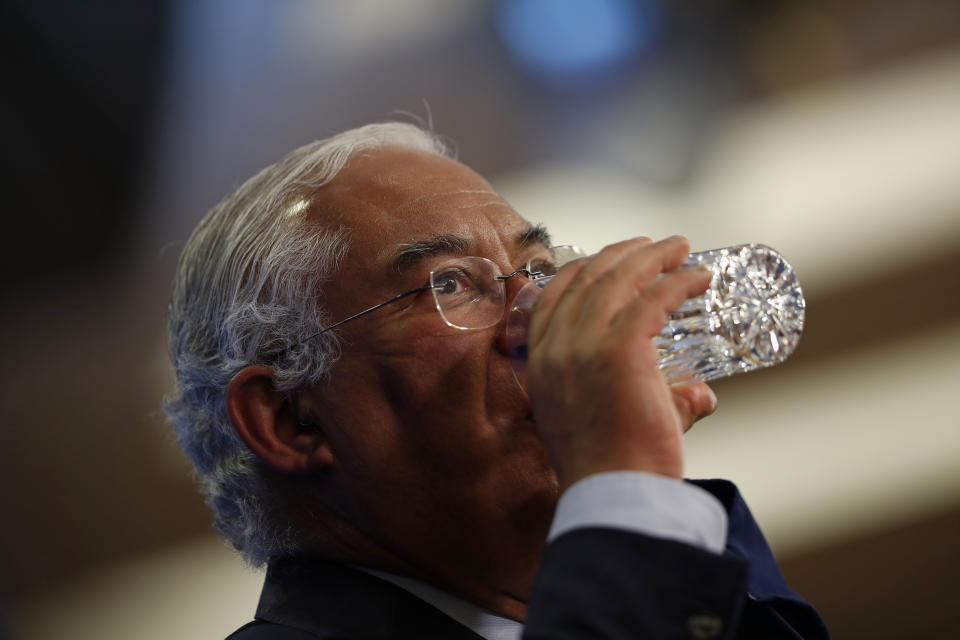 Portuguese Prime Minister Antonio Costa drinks during a joint news conference with European Commission President Ursula Von Der Leyen and European Parliament President David Sassoli after a plenary session at the European Parliament in Brussels, Wednesday, Jan. 20, 2021. During the session Costa presented the main lines of the programme of activities of the Portuguese Presidency. (AP Photo/Francisco Seco)