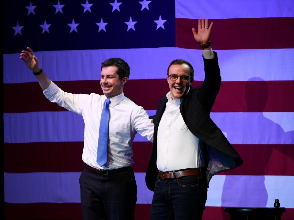 chasten and pete buttigieg waving in front of american flag