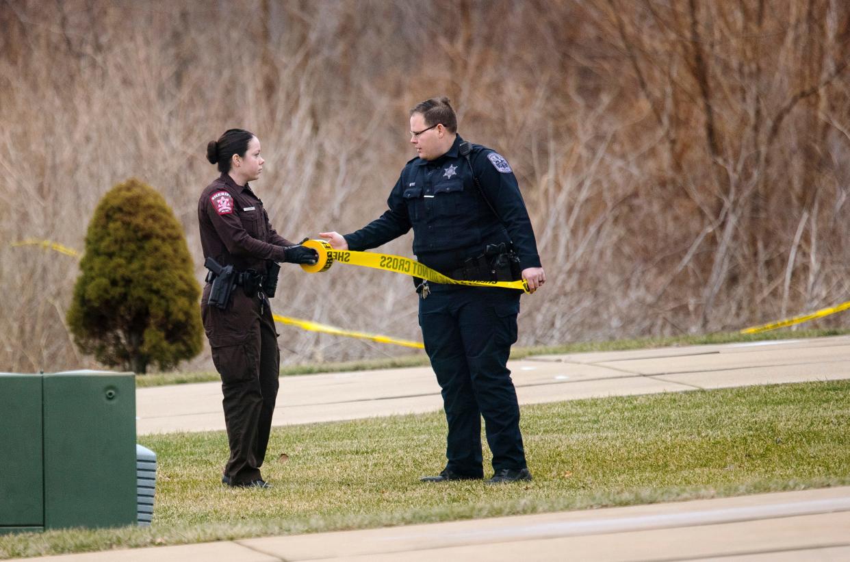 A Sangamon County Sheriff's deputy and a Rochester Police officer establish a perimeter near the scene of an airplane crash in Springfield, Illinois, Tuesday, Jan. 28, 2020. The Springfield Airport Authority confirmed that the plane went down shortly after 3 p.m. and was heading inbound towards Abraham Lincoln Capitol Airport. (Ted Schurter/The State Journal-Register)