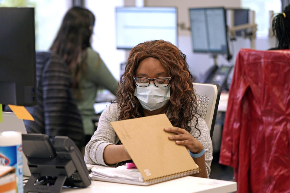 Contact tracer Astrid Zeroual works at Harris County Public Health contact tracing facility Thursday, June 25, 2020, in Houston. Texas Gov. Greg Abbott said Wednesday that the state is facing a "massive outbreak" in the coronavirus pandemic and that some new local restrictions may be needed to protect hospital space for new patients. (AP Photo/David J. Phillip)