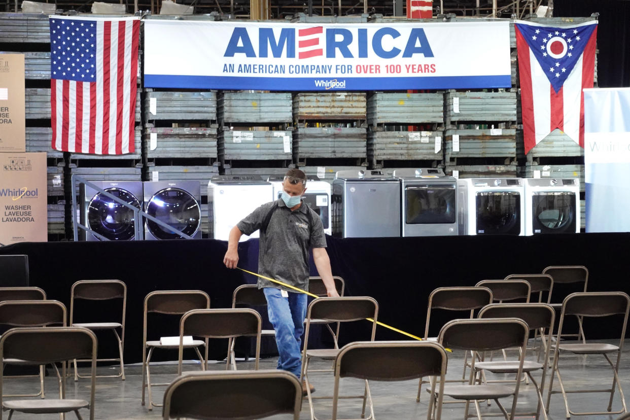 A worker checks for proper social distancing of guest seating prior to a visit from President Donald Trump at a Whirlpool manufacturing facility on August 06, 2020 in Clyde, Ohio. (Photo by Scott Olson/Getty Images)