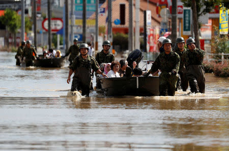 Japan Self-Defence Force soldiers rescue people from a flooded area in Mabi town in Kurashiki, Okayama Prefecture, Japan, July 8, 2018. Picture taken July 8, 2018. REUTERS/Issei Kato