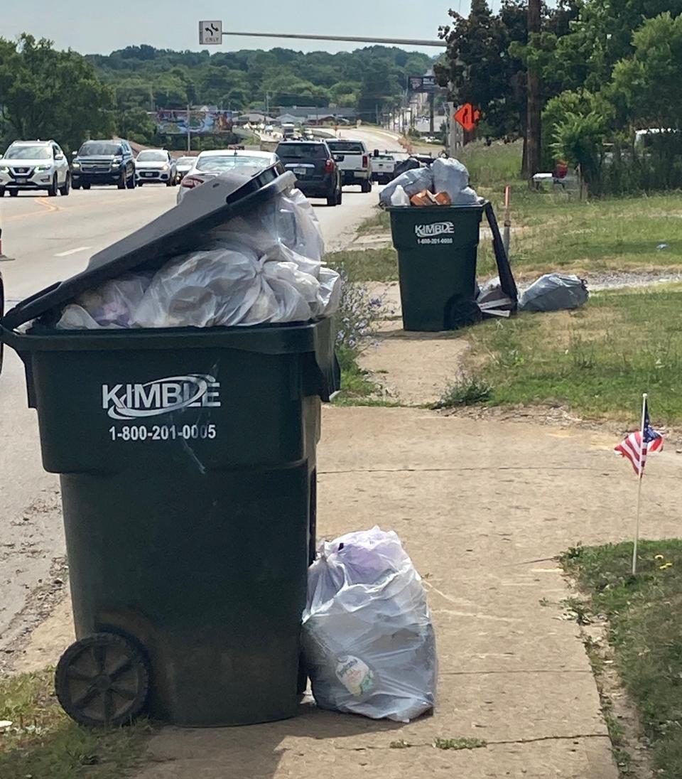 Trash containers were overflowing Wednesday along U.S. Route 62 in Canton.