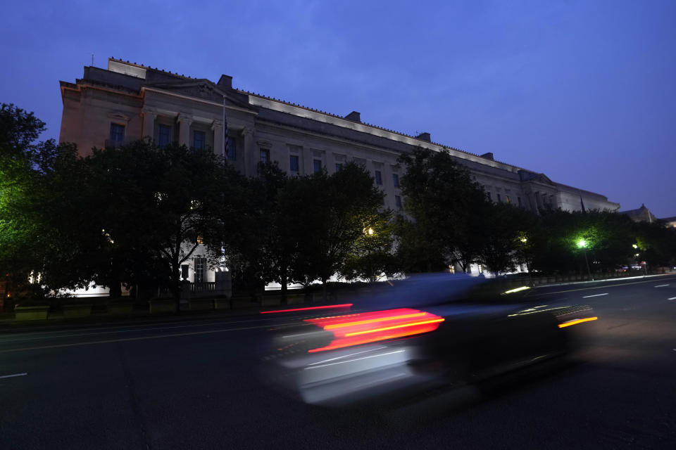 A car passes the Department of Justice on Pennsylvania Avenue Thursday, June 8, 2023, in Washington. Former President Donald Trump says he's been indicted on charges of mishandling classified documents at his Florida estate, igniting a federal prosecution that is arguably the most perilous of multiple legal threats against the former president as he seeks to reclaim the White House. (AP Photo/Manuel Balce Ceneta)