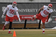 Kansas City Chiefs defensive tackles Chris Jones (95) and Mike Pennel Jr. (69) stretch during the NFL football team's practice Friday, Jan. 26, 2024, in Kansas City, Mo. (AP Photo/Charlie Riedel)