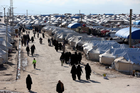 Women walk through al-Hol displacement camp in Hasaka governorate, Syria April 1, 2019. REUTERS/Ali Hashisho/Files