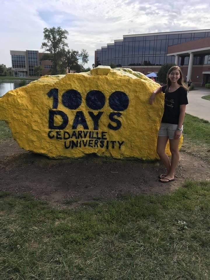 Wenig stands next to the Cedarville rock during Getting Started Weekend in August 2019.