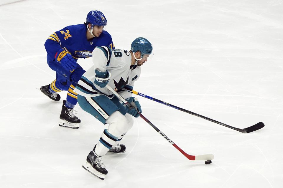 Buffalo Sabres' Dylan Cozens (24) chases after the San Jose Sharks' Tomas Hertl (48) during an NHL hockey game at KeyBank Center in Buffalo, N.Y., Monday, Jan. 15, 2024. (Libby March//The Buffalo News via AP)