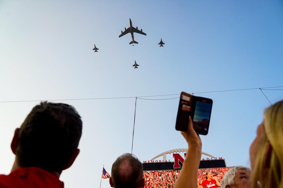 A KC-135 and three F-16 jets fly over Memorial Stadium during the national anthem before the match between the Nebraska Cornhuskers and the Omaha Mavericks.