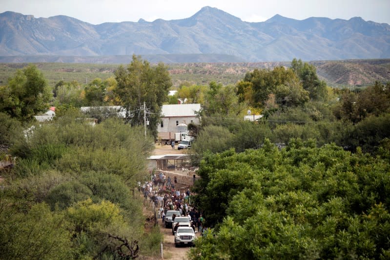 Relatives in pickup trucks transport the remains of Dawna Ray Langford and her sons Trevor, Rogan, who were killed by unknown assailants, to be buried at the cemetery in La Mora